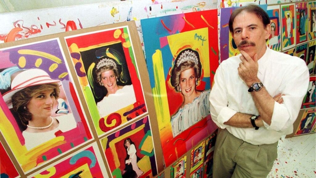 FILE PHOTO: Artist Peter Max poses near pictures of Diana, Princess of Wales, in his New York studio, U.S., August 25, 1998. Reuters/Peter Morgan/File Photo