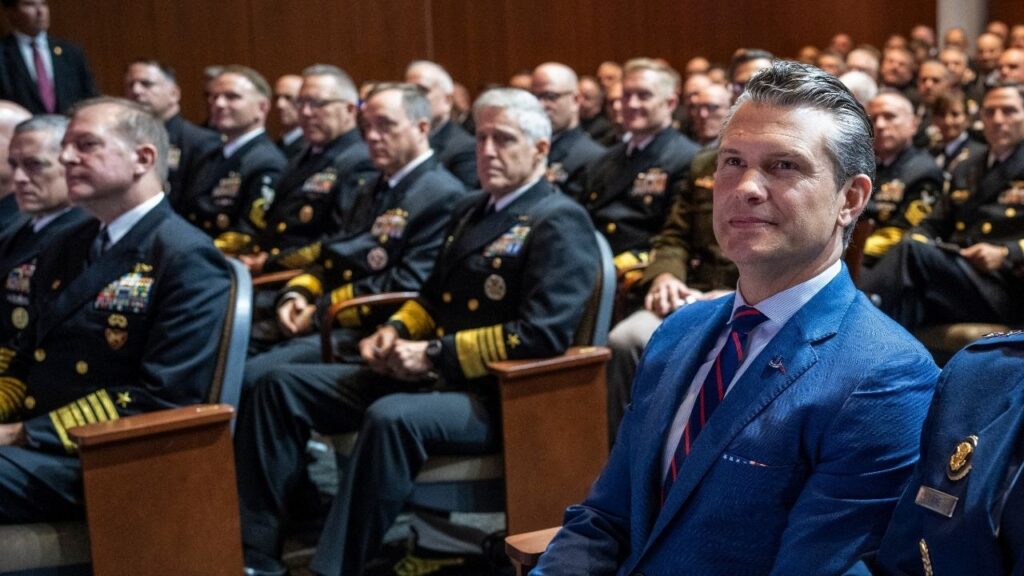 Secretary of Defense Pete Hegseth watches as President Donald Trump delivers remarks to military leadership in Quantico, Va., Sept. 30, 2025. Hegseth has fired or blocked the promotions of more than 80 generals and admirals, a purge that has hit about 10 percent of the military’s top-ranking officers and shows no signs of slowing. (Doug Mills/The New York Times)