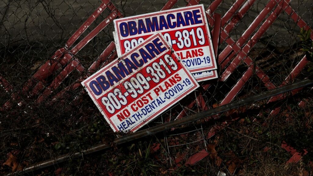 Signs for former Obamacare health insurance plans lay next to a fence in Columbia, South Carolina, U.S., January 28, 2023. REUTERS/Shannon Stapleton