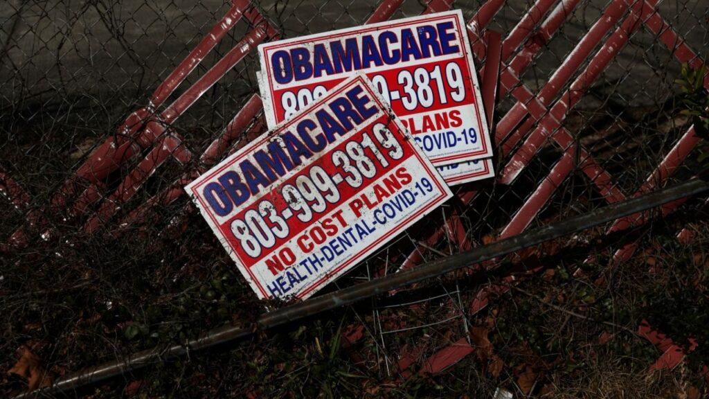 Signs for former Obamacare health insurance plans lay next to a fence in Columbia, South Carolina, U.S., January 28, 2023. REUTERS/Shannon Stapleton