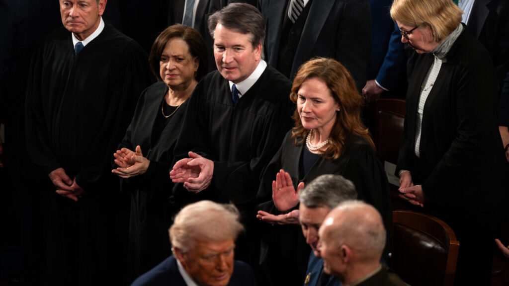 Image of President Trump walking past the Supreme Court justices to greet Gen. Dan Caine on the House floor.