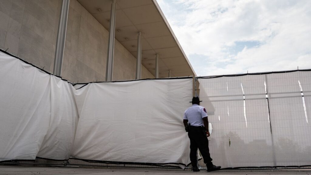Temporary fencing restricts access and views of the John F. Kennedy Center for the Performing Arts, in Washington, Sept. 17, 2026. Internal emails and documents demonstrate the Trump administration’s political capture of the Kennedy Center, including how officials once pursued a plan to unload much of the art collection. (Salwan Georges/The New York Times)