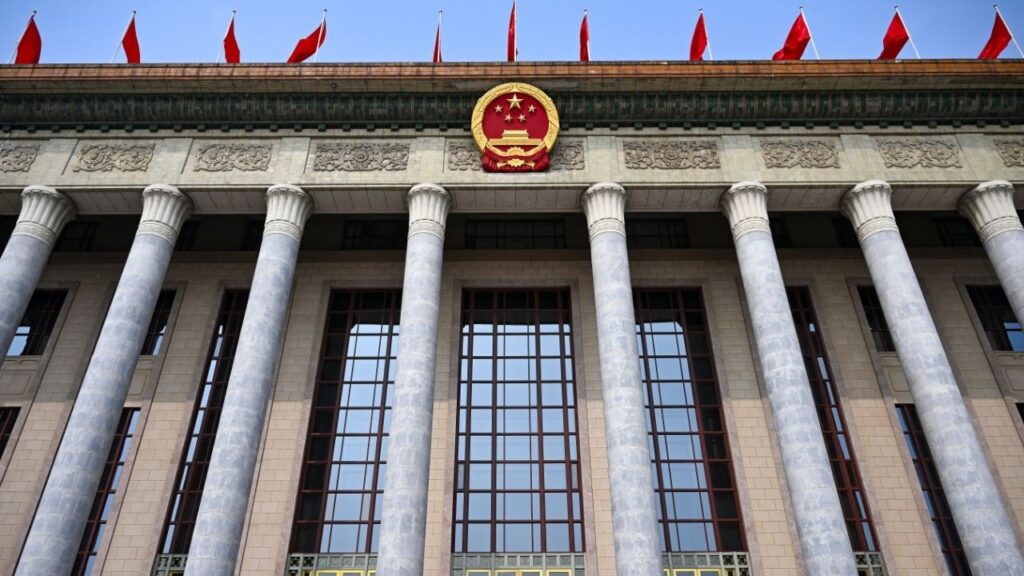 The Great Hall of the People in Beijing, May 14, 2026. Even as China urges the United States not to hype the dangers of AI, its own spy chief is framing the technology as a threat to the Communist Party’s security. (Kenny Holston/The New York Times)