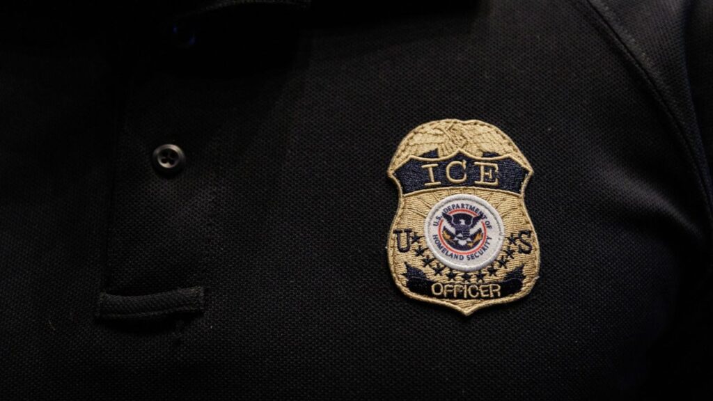The badge of a U.S. Immigration and Customs Enforcement (ICE) is embroidered on a polo shirt of an ICE employee, at a U.S. Immigration and Customs Enforcement two-day job fair in Texas to help fill vacancies for deportation officers and attorneys, in Arlington, Texas, U.S. August 26, 2025. REUTERS/Shelby Tauber