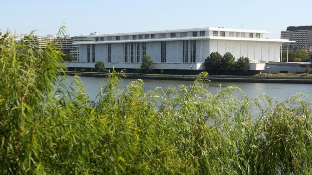FILE PHOTO: A view of the John F. Kennedy Center for the Performing Arts above tree branches, after President Donald Trump's administration ​argued in a court filing that the building could eventually face demolition ‌if major repairs are not undertaken, in Washington, D.C., U.S., August 26, 2026. Reuters/Kevin Lamarque/File Photo