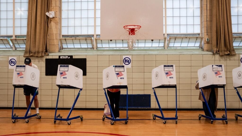 Voters cast their ballots at a polling site during a primary election in New York on June 23, 2026. Civil rights groups sued the Trump administration on Friday, Sept. 18, asserting that its aggressive immigration enforcement and threats to send armed agents to polling sites amounted to voter intimidation and violated the Voting Rights Act. (Angelina Katsanis/The New York Times)