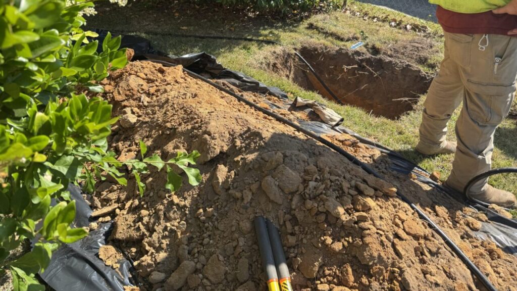 Image of a hole in the ground where a news residential gas line is being installed