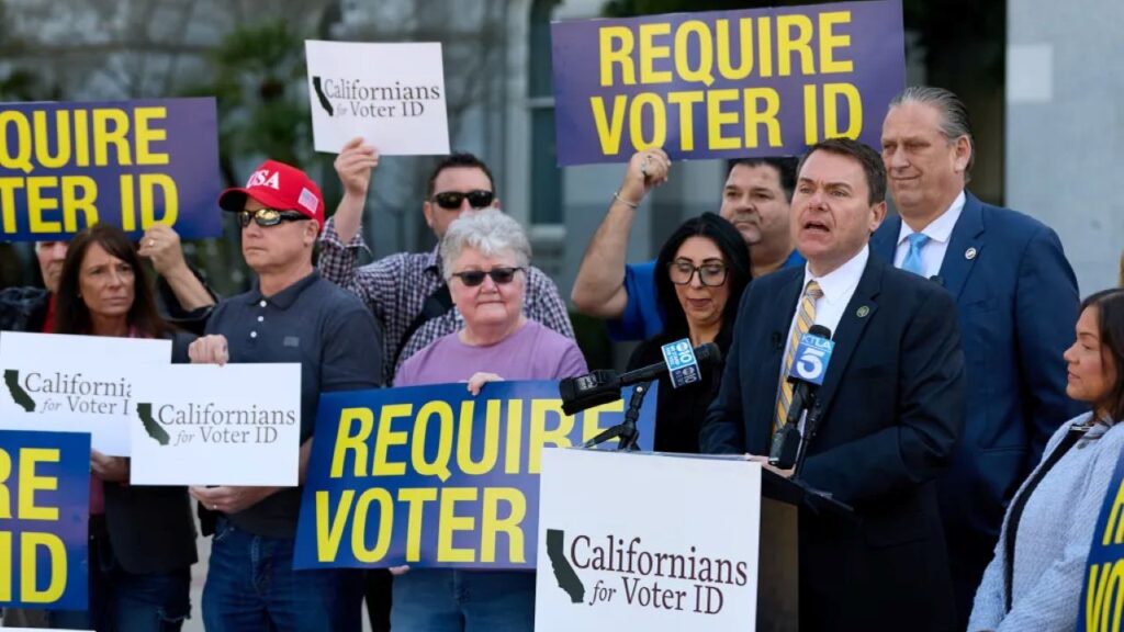 Image of California voter ID requirement at a Sacramento news conference holding signs