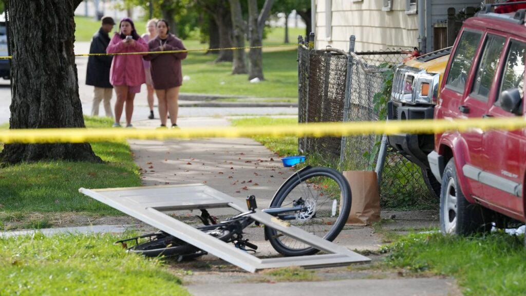 Image of bystanders looking at a mass shooting scene