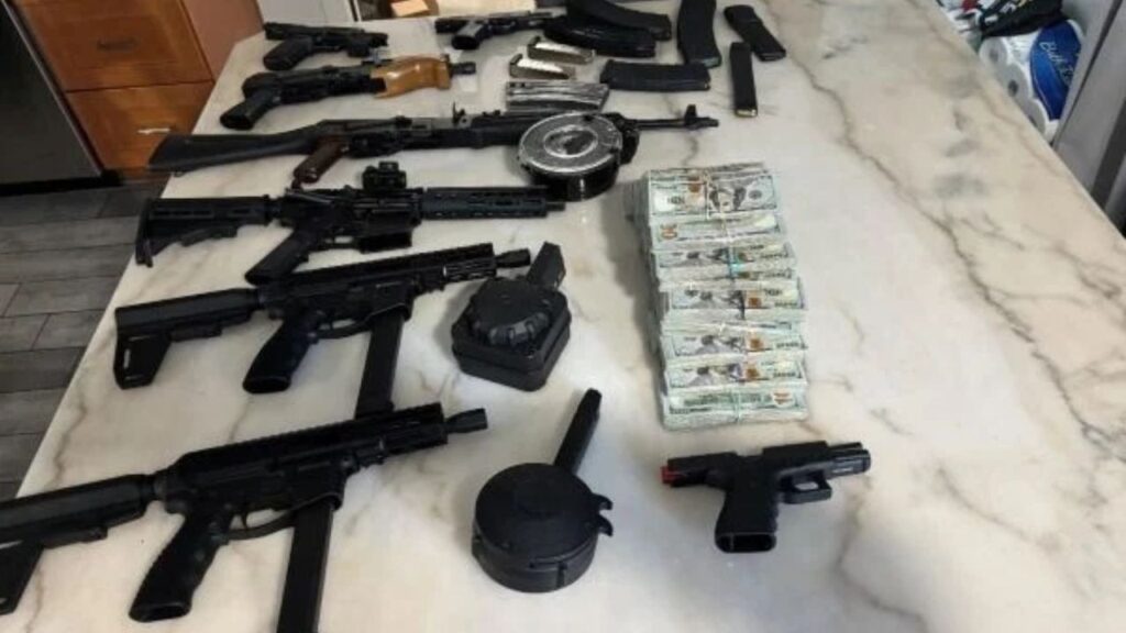 A Mexican citizen living illegally in the United States faces federal firearms charges after investigators recovered guns stolen from a moving train, a machine gun, and nearly $350,000 in cash. (DOJ)