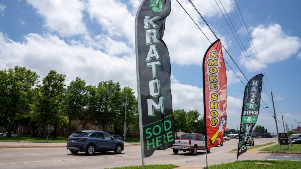 A banner promotes kratom outside of a smoke shop in Tulsa, Okla., June 8, 2026. Health officials will now allow some levels of a powerful substance to remain in products marketed as natural. The change could help a G.O.P. donor facing wrongful death lawsuits. (Nick Oxford/The New York Times)