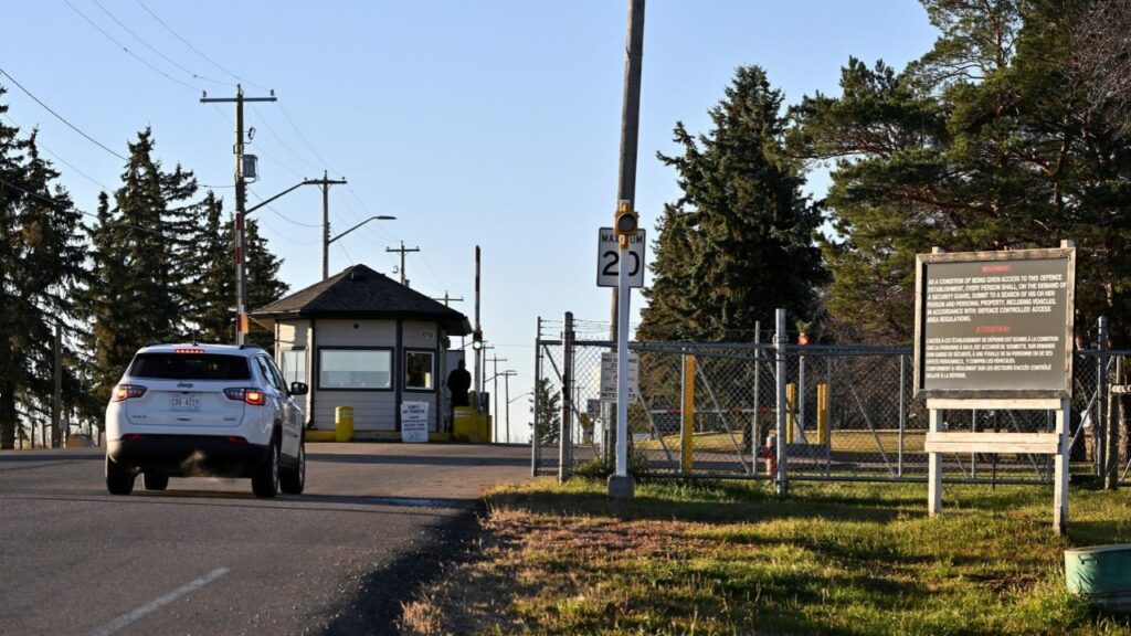 A car drives near the gate of Canadian Forces Base (CFB) Wainwright, the day after a serious incident that resulted in a fire caused deaths and injuries, in Wainwright, Alberta, Canada, October 18, 2026. REUTERS/Jennifer Gauthier