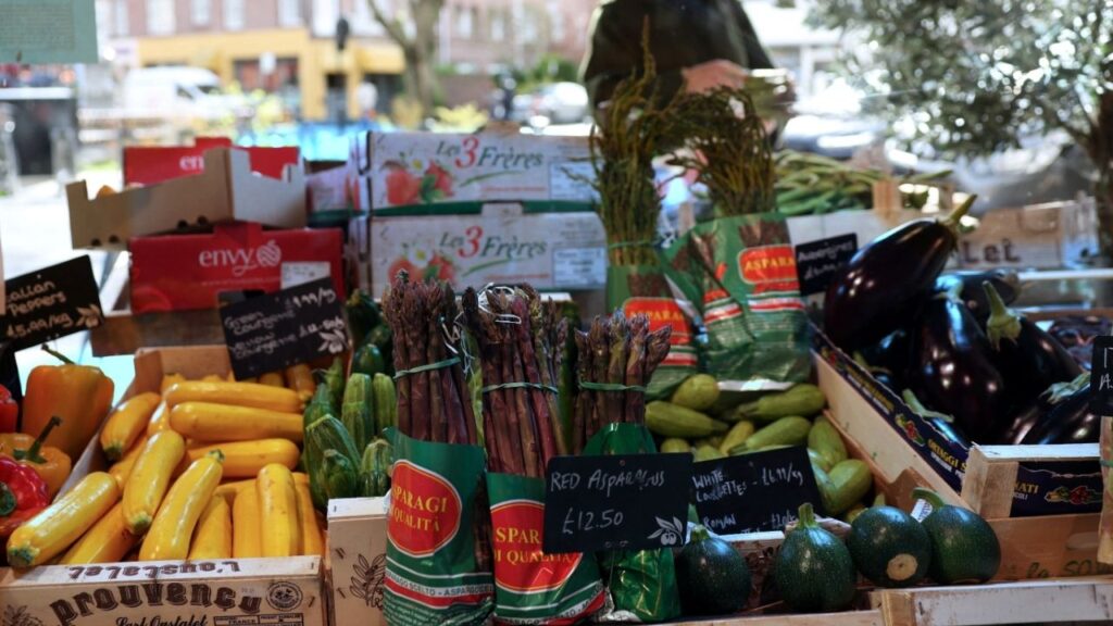 A customer shops for vegetables at gourmet grocery store Andreas, in London, Britain, March 28, 2024. REUTERS/Isabel Infantes