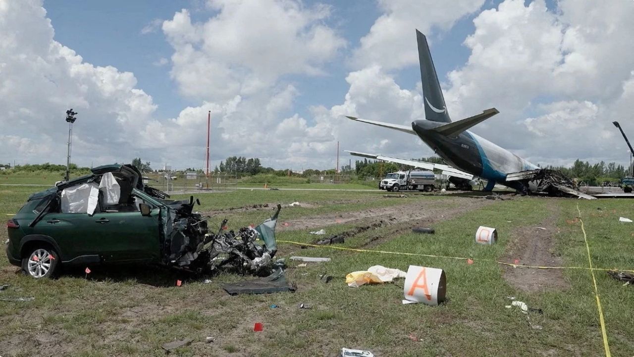 A damaged car next to the wreckage of an Amazon Prime Air cargo plane overran a runway at Miami International Airport, in Miami, Florida, U.S., in this screengrab obtained from a handout video released on September 8, 2026. (Reuters File)