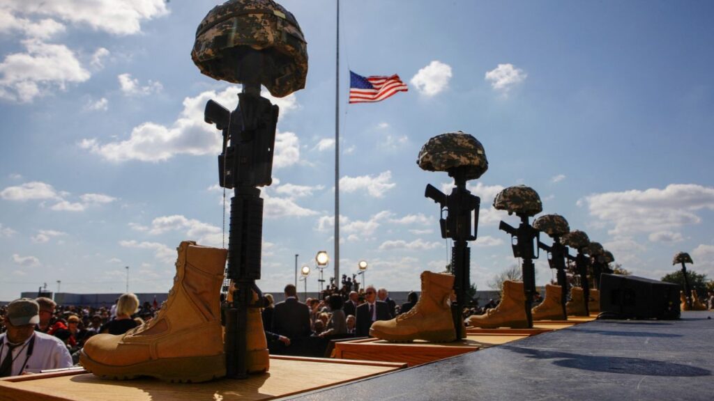 A flag at half-staff is framed by helmets, rifles and boots at Fort Hood, Texas, Nov. 10, 2009, prior to a memorial for those killed at the post on Nov. 5, 2009. Maj. Nidal Malik Hasan will be executed by firing squad at Fort Hood, Texas, on Dec. 3, for fatally shooting 13 people and wounding 32 in 2009 at the same base, the Army said in a statement on Wednesday, Oct. 7, 2026. (Doug Mills/The New York Times)