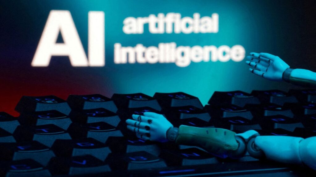 A message reading "AI artificial intelligence", a keyboard, and robot hands are seen in this illustration taken January 27, 2025. (Reuters File)
