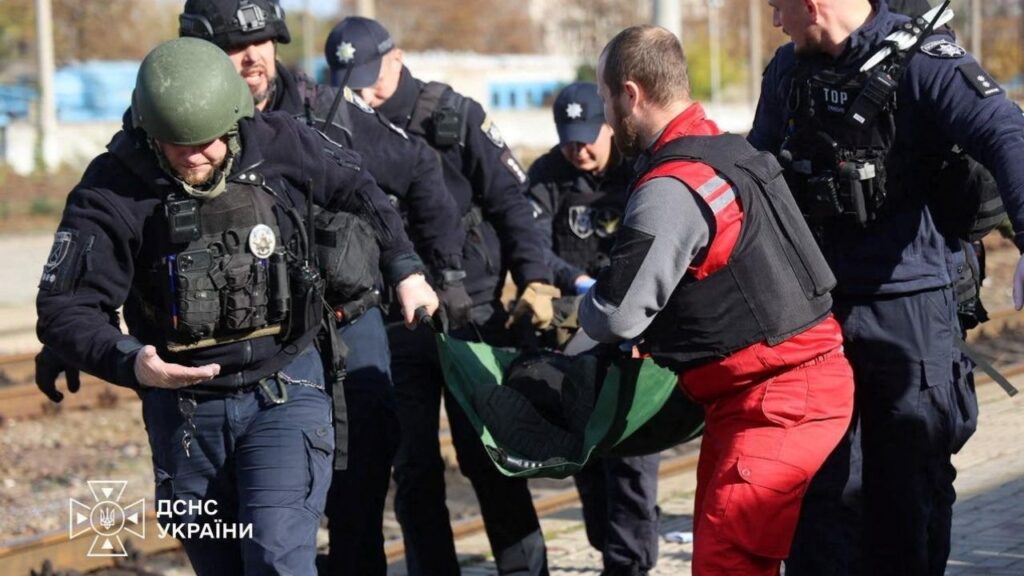A paramedic and police officers carry a person injured at a railway station during a Russian drone strike, amid Russia's attack on Ukraine, in Dnipro, Ukraine October 29, 2026. Press service of the State Emergency Service of Ukraine in Dnipropetrovsk region/Handout via REUTERS