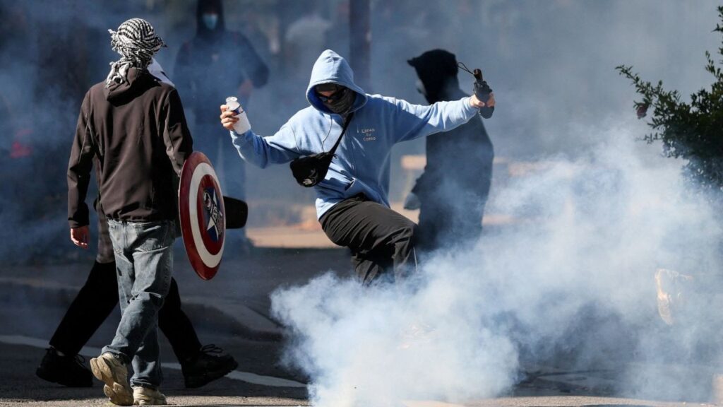 A person kicks a tear gas canister as French high school and university students attend a demonstration, part of a nationwide day of protests and blockades to demand better school conditions, in Nantes, France, October 8, 2026. REUTERS/Stephane Mahe