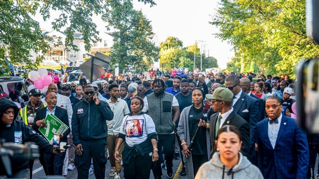 A photo provided by the Baltimore Police Department shows people gathering for a peace walk in Baltimore on Monday, Oct. 5, 2026, two days after a 12-year-old girl, Khloe Ishway, was shot and killed. A man has been charged with murder after the authorities said he exchanged gunfire with another man during an argument over a parking spot in Baltimore on Saturday, killing a 12-year-old girl who was caught in the crossfire. (Baltimore Police Department via The New York Times)