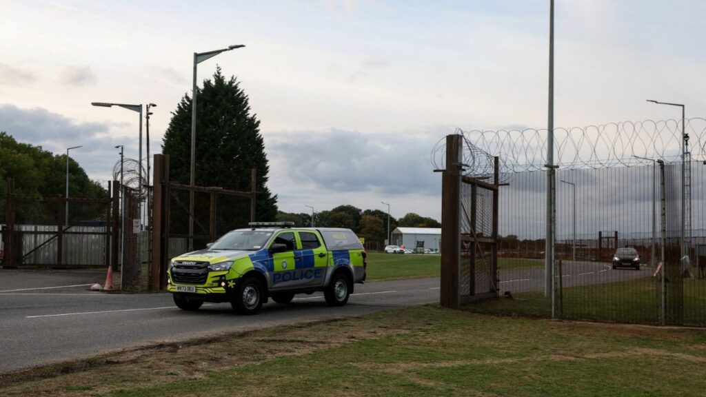 A police car leaves RAF Molesworth, after two Latvian nationals were arrested on suspicion of entering a prohibited place for a purpose prejudicial to the UK, police said in a statement, in Cambridgeshire, Britain, October 8, 2026. REUTERS/Chris Radburn