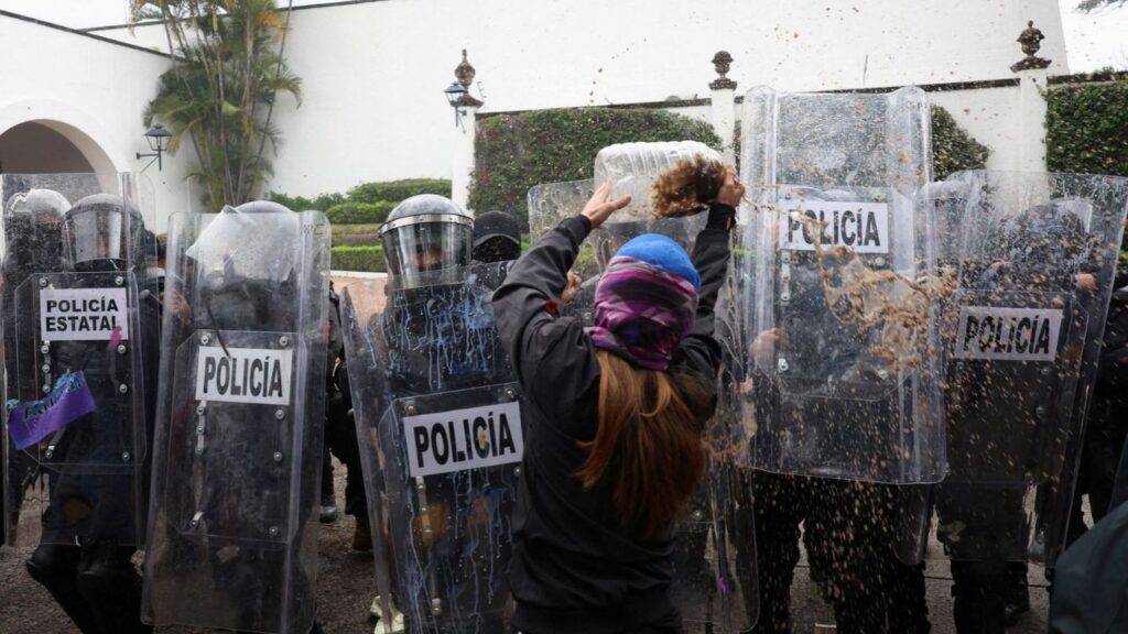 A protester throws dirty water at state riot police during a demonstration demanding clean water after weeks of residents' complaints about discolored and foul-smelling water in parts of the metropolitan area, outside Casa Jalisco, the official residence of the state governor, in Guadalajara, Mexico, October 11, 2026. REUTERS/Stringer