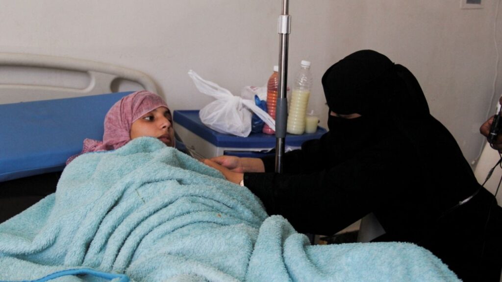 A relative helps Amal al-Sabri, a 25-year-old pregnant mother of two, at a hospital where she is being treated after a bullet pierced her pregnant belly and shattered her spine in the besieged mountains of Taiz, Yemen, October 26, 2026. REUTERS/Anees Mahyoub
