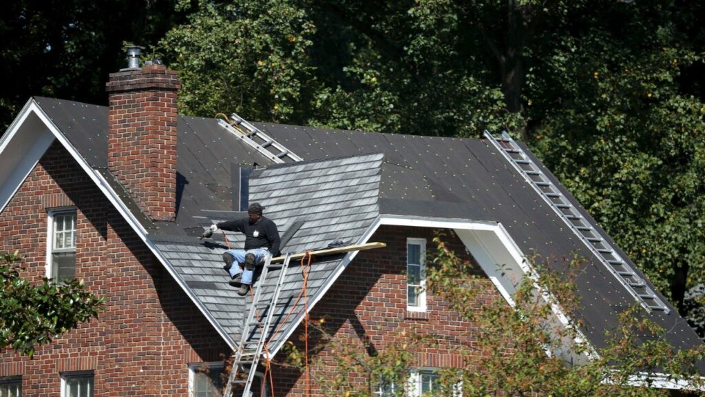 A roofer nails on shingles at a job site in northwest Washington September 15, 2015. (Reuters/Gary Cameron)