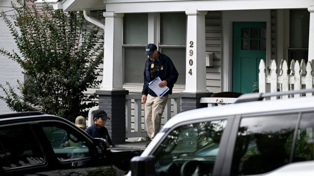 Agents of the Homeland Security Investigations (HSI) work at the entrance of the residence of US Rep. Ilhan Omar (D-MN), after US authorities conducted a raid as part of an ongoing investigation by the Justice Department, in Washington, DC, US, October 12, 2026. REUTERS/Annabelle Gordon