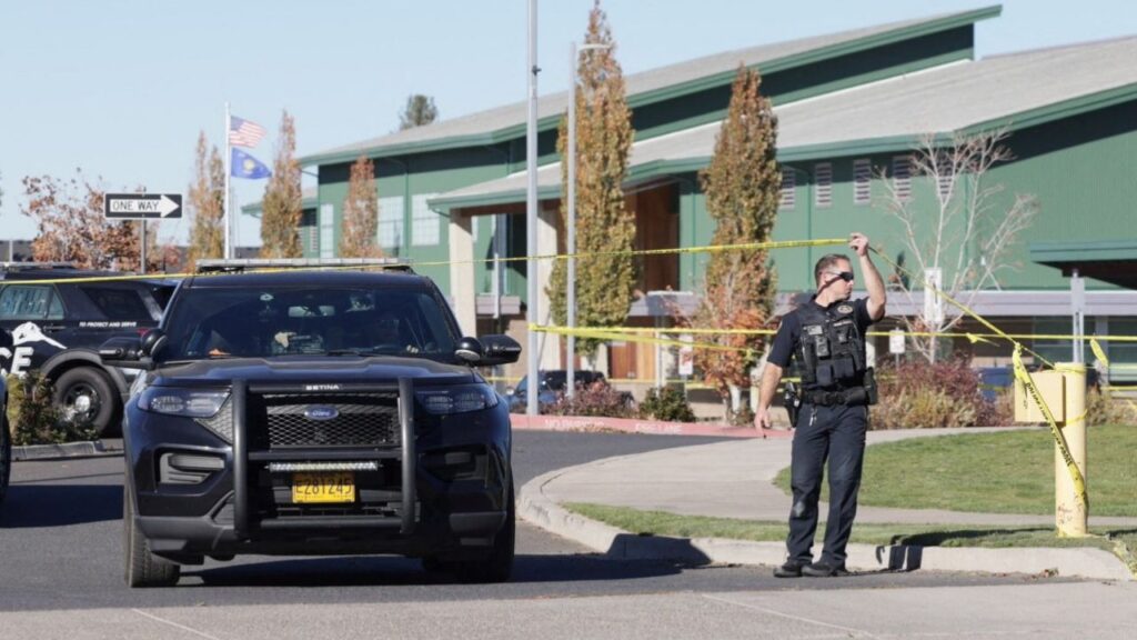 An emergency worker holds up police tape at the scene of a shooting at Silver Rail Elementary School in Bend, Oregon, US, October 15, 2026. REUTERS/Rob Kerr