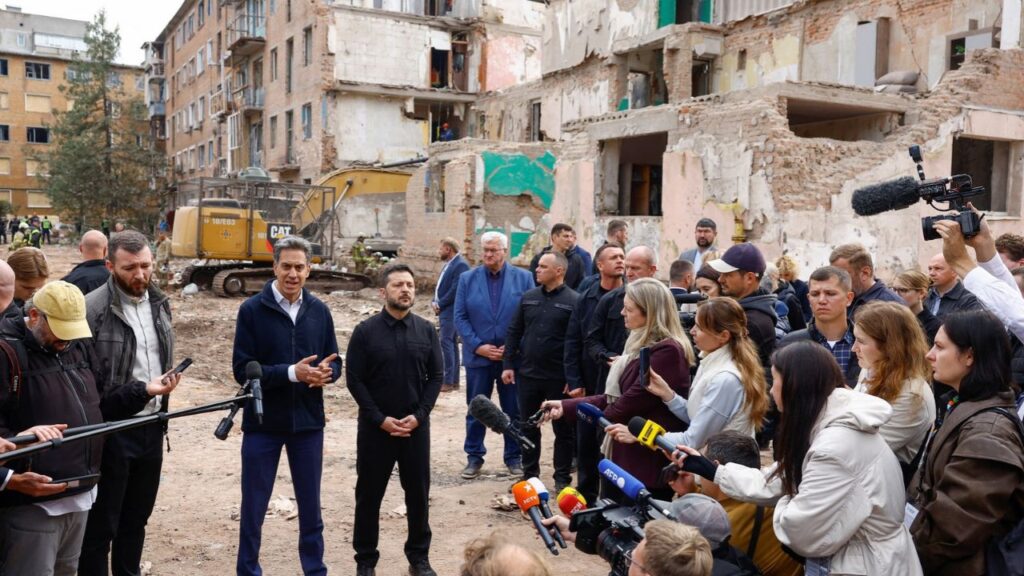British Foreign Secretary Ed Miliband and Ukraine's President Volodymyr Zelenskiy speak to the media while they visit the site of an apartment building where 22 residents were killed yesterday morning by a Russian missile strike in the town of Pryluky, amid Russia's attack on Ukraine, in the Chernihiv region, Ukraine, October 8, 2026. REUTERS/Valentyn Ogirenko