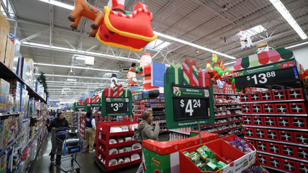 Customers walk through holiday shopping displays at a Walmart Supercenter retail store in North Bergen, New Jersey, U.S., November 21, 2025. REUTERS/Mike Segar