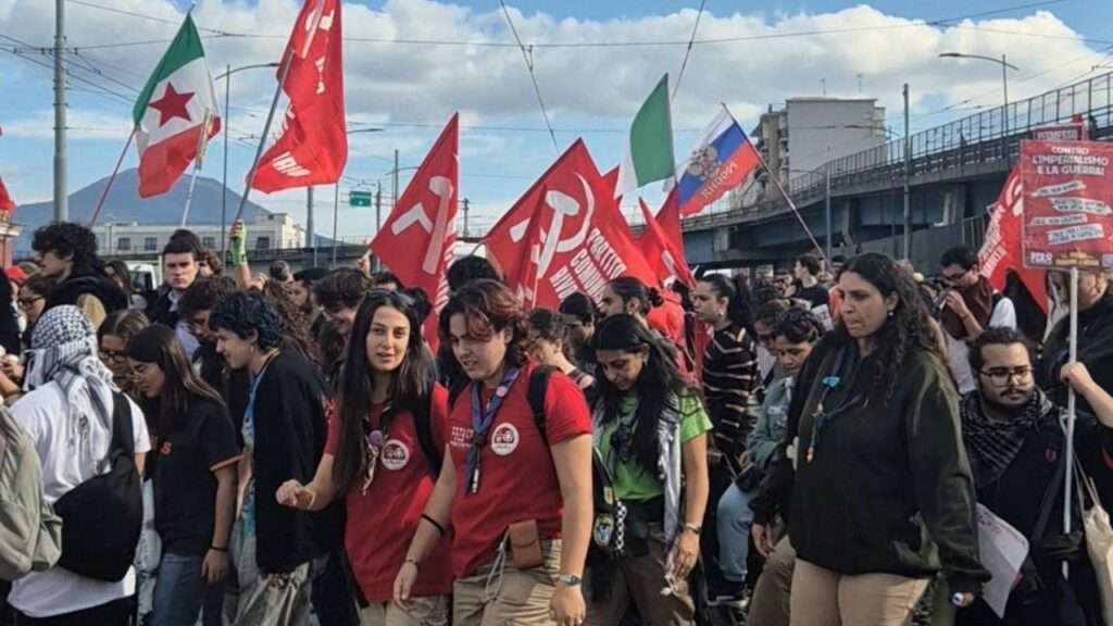 Demonstrators walk across rail tracks during a nationwide strike called by the USB trade union to protest against rising living costs and military spending, in Naples, Italy, October 30, 2026, in this still image obtained from a social media video. Sonia Totaro/via REUTERS
