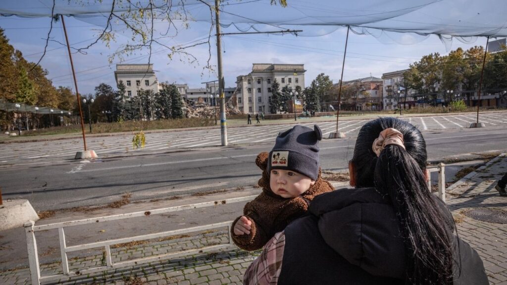 Eight-month-old Davyd, with his mother Oleksandra, takes a walk under net-covered streets normally threatened by Russian artillery and drones in Kherson, Ukraine, on Wednesday Oct. 28, 2026. A rare localized peace deal announced by the first lady, Melania Trump, offered a brief respite for Kherson, where Russian drones and artillery have long terrorized civilians. (David Guttenfelder/The New York Times)