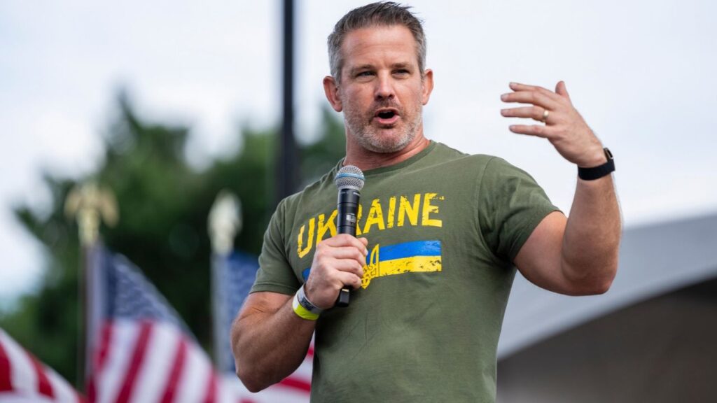 Former Rep. Adam Kinzinger, who was a member of the House select committee that investigated the January 2021 attack on the Capitol, speaks during a rally on the National Mall in Washington, June 6, 2025. A federal financial watchdog is investigating Kinzinger for bets in a prediction market on whether President Joe Biden would pardon him before leaving office. (Eric Lee/The New York Times)