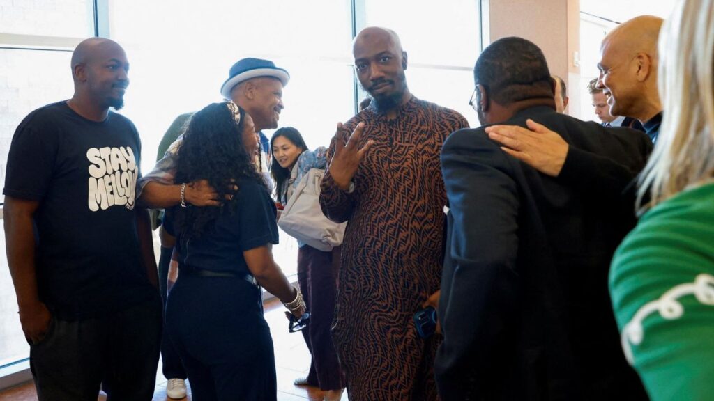 Friends and family members of rapper Tupac Shakur, and Darryl Harper, second left with hat, who says he is Shakur's music producer, celebrate outside a courtroom after a jury found Duane Davis, not photographed, guilty in the 1996 killing of Shakur, in Clark County District Court at the Regional Justice Center on Monday, Aug. 31, 2026, in Las Vegas. Bizuayehu Tesfaye/Pool via REUTERS
