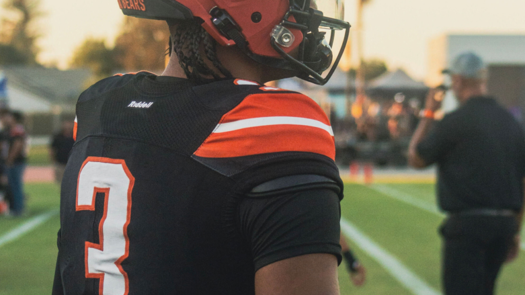 Image of a football player facing right on a football field