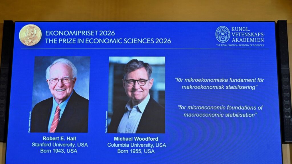 Images of Robert E. Hall and Michael Woodford are displayed as they are announced as the laureates of the 2026 Sveriges Riksbank Prize in Economic Sciences in Memory of Alfred Nobel at the Royal Swedish Academy of Sciences in Stockholm, Sweden, on October 12, 2026. TT News Agency/Anders Wiklund via REUTERS
