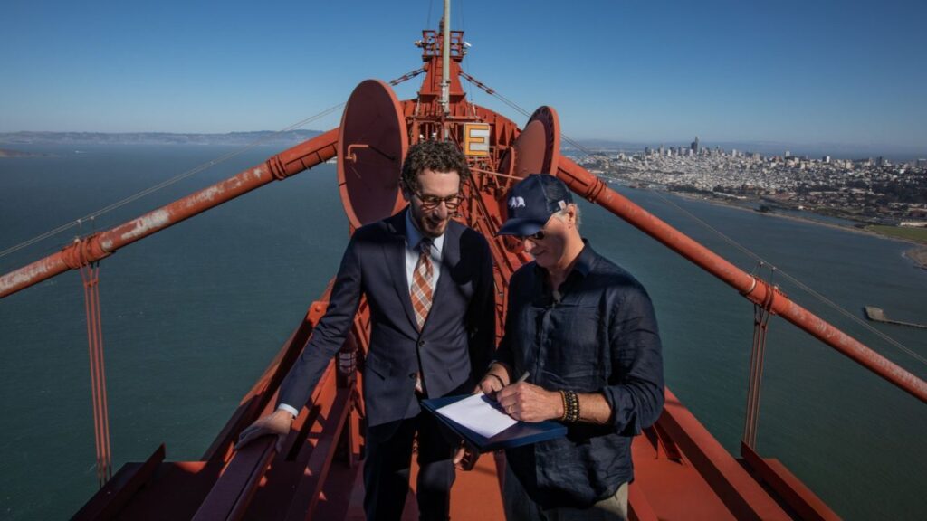 Joined by State Sen. Scott Wiener at left, Gov. Gavin Newsom visits the top of a tower of the Golden Gate Bridge to sign a bill, ostensibly the last of eight years in office, in San Francisco on Sept. 29, 2026. Newsom skipped the cramped elevator for a harnessed climb up one of the cables. Asked about presidential ambitions in 2028, he replied “We’ll see what fate brings. We’ll see what fate brings.” (Josh Haner/The New York Times)