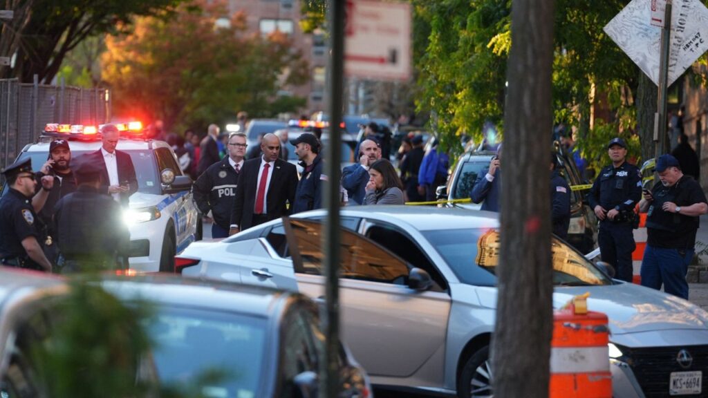 Members of law enforcement gather near a vehicle at the scene of a shooting reportedly involving US Immigration and Customs Enforcement (ICE) officers in the Bronx borough of New York City, US, October 8, 2026. REUTERS/David Dee Delgado