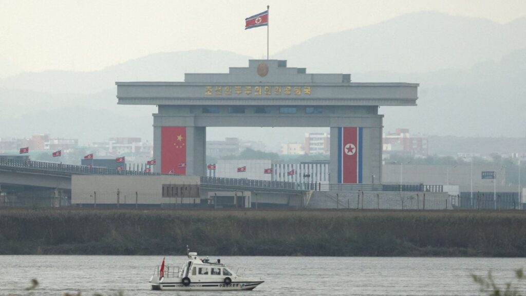 FILE PHOTO: A China Immigration inspection vessel travels along the Yalu river past a North Korean customs building at the end of the newly opened New Yalu River Bridge, which connects North Korea's Sinuiju from China's Dandong New Zone, as seen from Dandong, Liaoning province, China October 15, 2026. Reuters/Florence Lo/File Photo