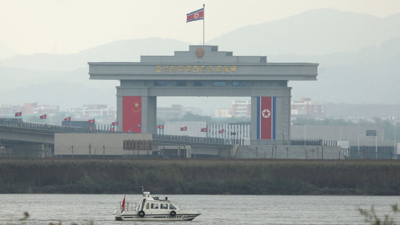 FILE PHOTO: A China Immigration inspection vessel travels along the Yalu river past a North Korean customs building at the end of the newly opened New Yalu River Bridge, which connects North Korea's Sinuiju from China's Dandong New Zone, as seen from Dandong, Liaoning province, China October 15, 2026. Reuters/Florence Lo/File Photo