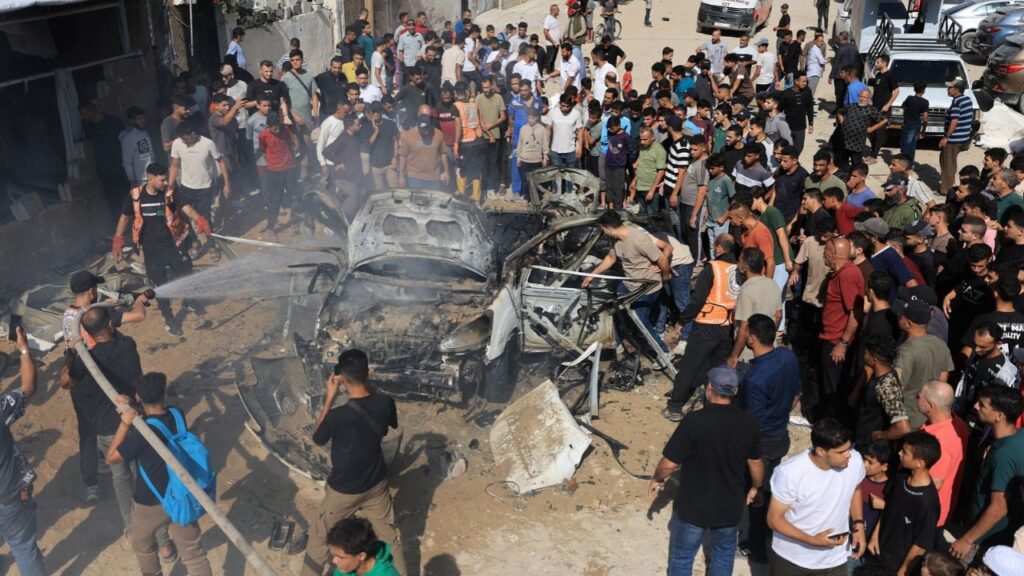 Palestinians spray a vehicle with water after it was hit by an Israeli strike, according to health officials, in Gaza City, October 22, 2026. REUTERS/Dawoud Abu Alkas