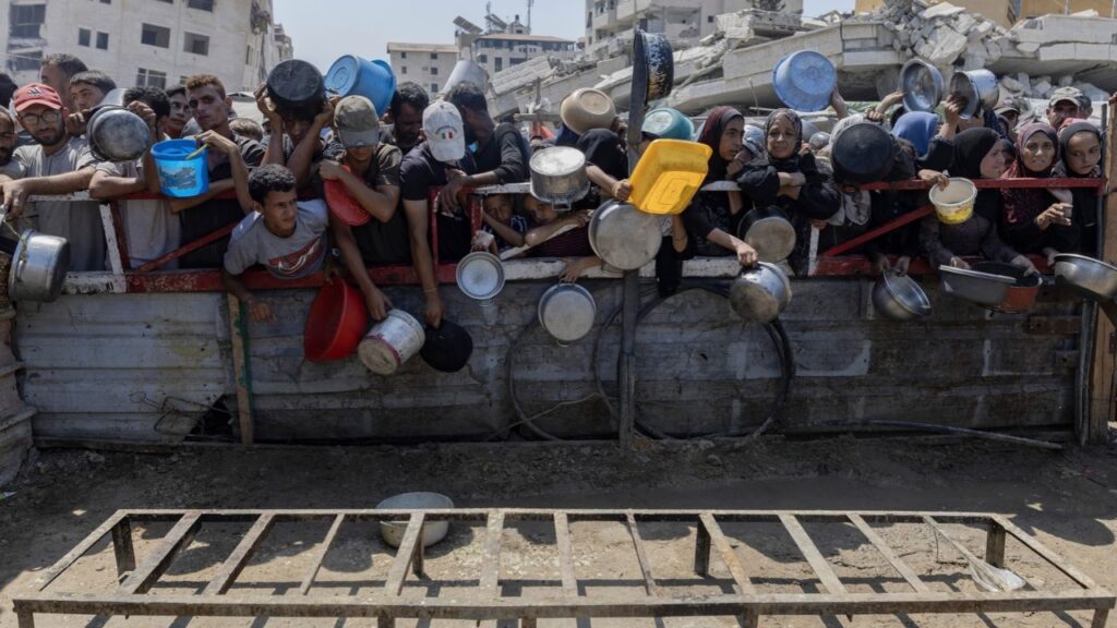 Palestinians wait for food distribution in Gaza City, July 23, 2025. Prime Minister Benjamin Netanyahu led Israel’s denunciations on Friday, Oct. 9, 2026, of the decision to award the Nobel Peace Prize to Navi Pillay, a human rights lawyer who was drawn into the international spotlight last year when a United Nations commission she chaired found that Israel was committing genocide against Palestinians in Gaza. (Saher Alghorra/The New York Times)
