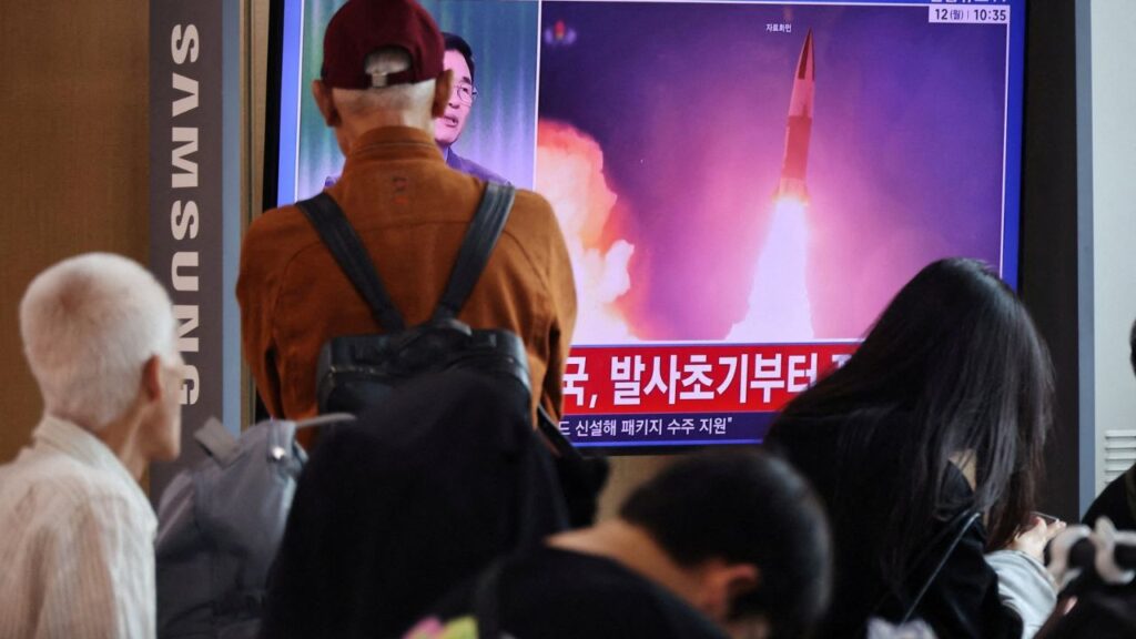 People watch a TV broadcasting a news report on North Korea firing multiple ballistic missiles toward the sea off its east coast, at a railway station in Seoul, South Korea, October 12, 2026. REUTERS/Kim Hong-Ji