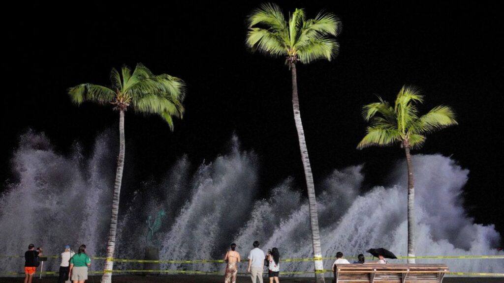 People watch waves crash against the waterfront promenade as Hurricane Simon approaches Mexico's Pacific coast in Puerto Vallarta, Mexico, October 11, 2026. REUTERS/Christian Ruano