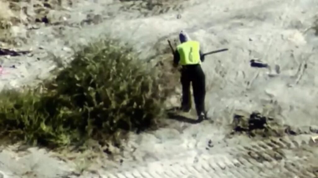 Porterville police arrested a masked man Wednesday after a drone spotted him carrying what appeared to be a rifle near the Tule River. (Porterville PD)
