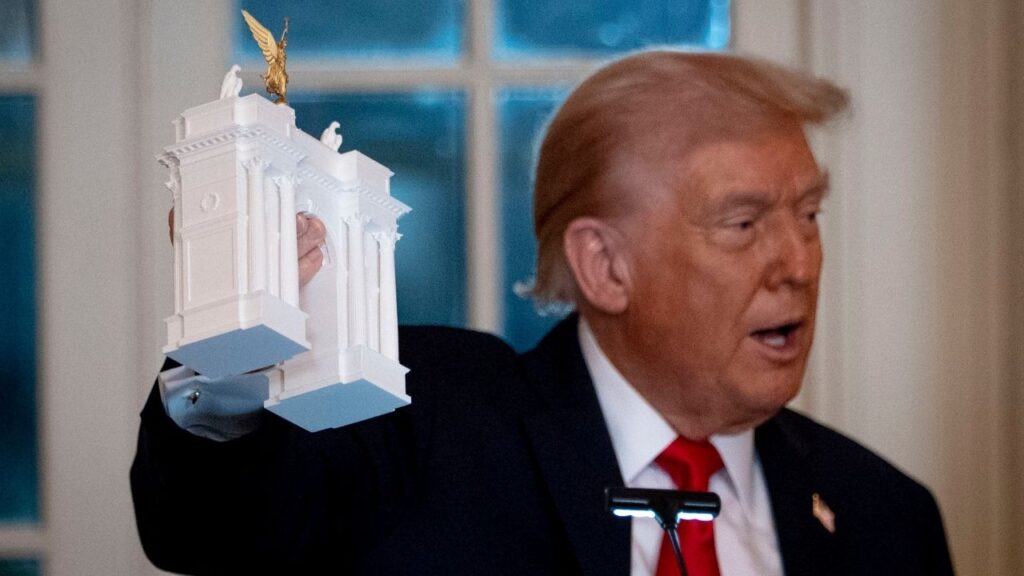 President Donald Trump holds a model of his proposed “Independence Arch” during a fundraising dinner in the East Room of the White House in Washington, Oct, 16, 2025. With litigation threatening to derail President Trump’s plans for a 250-foot triumphal arch in Washington, two of his top aides on Wednesday, Oct. 28, 2026, submitted sworn statements to a federal court claiming that the arch was needed for national security purposes. (Doug Mills/The New York Times)