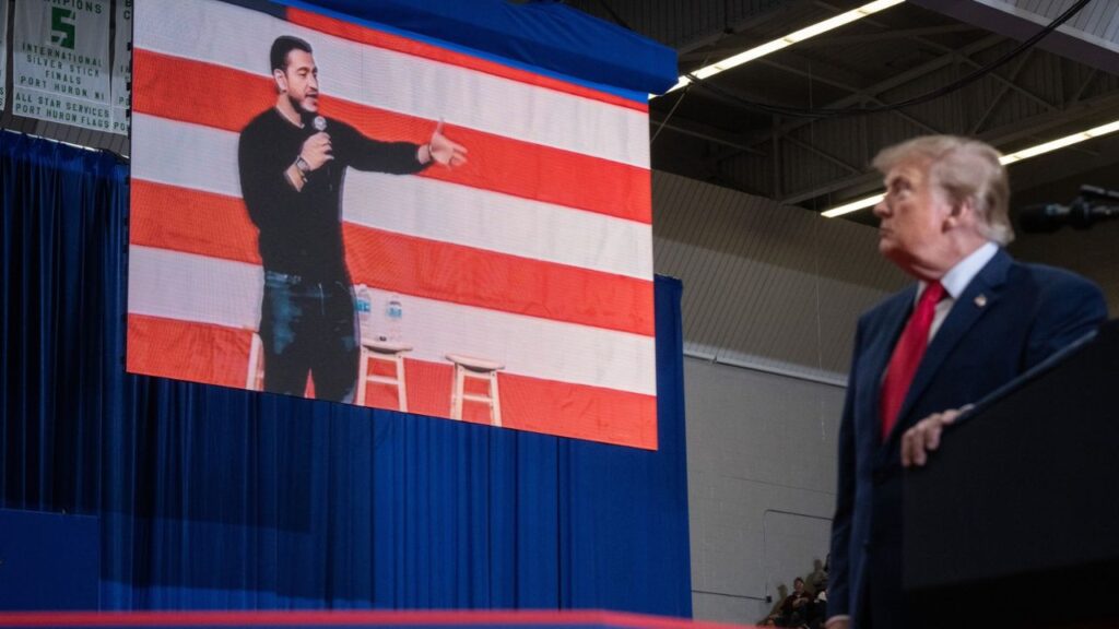 President Donald Trump shows a video of Dr. Abdul El-Sayed, the Democratic senate nominee in Michigan during a Republican campaign rally in Port Huron, Mich., on Sunday, Oct. 25, 2026. The Senate race in Michigan has exposed electoral fault lines over religion, race, inflation, tariffs and, of course, the Trump presidency. It may also be the most consequential contest for Democrats looking ahead to 2028. (Haiyun Jiang/The New York Times)