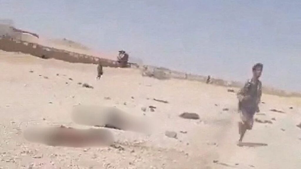 A screengrab from a video shows a person walking near bodies in the aftermath of a Houthi attack on Yemeni government military camp in Shabwa, Yemen, October 19, 2026. Social Media via REUTERS