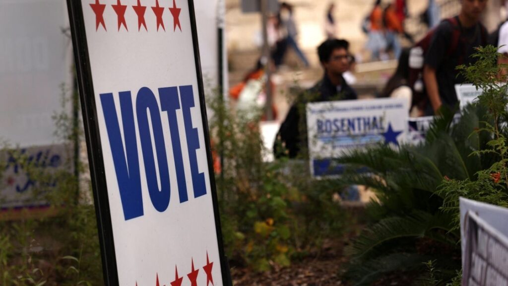 Students walk past signs near an early voting location on the campus of The University of Texas at Austin during early voting ahead of the November 3rd US midterm elections in Austin, Texas, US, October 27, 2026. REUTERS/Mike Segar